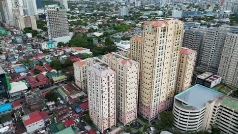 Aerial-dolly-shot-of-towering-apartment-buildings-in-a-highly-urbanized-area-of-San-Juan-City,-Manila,-Philippines