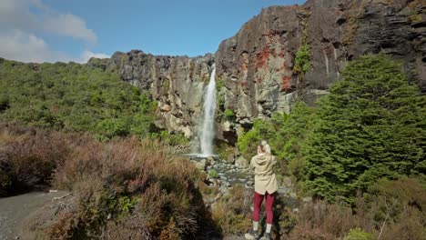 Lone-female-photographer-taking-pictures-of-beautiful-Taranaki-waterfall