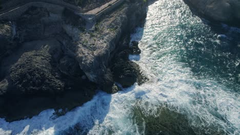 Aerial-Rocky-coastline-hit-waves,-relaxing-calming-sea-in-Mallorca,-Spain