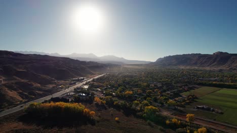 Drone-shot-flying-south-over-Moab,-Utah-in-the-morning-with-fog-haze