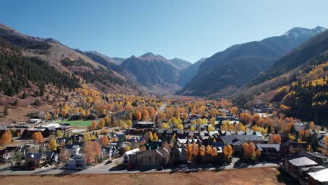 Slow-and-cinematic-drone-shot-flying-across-downtown-Telluride,-CO-in-the-fall