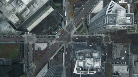 Diagonal-intersection-cuts-across-bustling-high-rise-buildings-of-Seattle,-aerial-bird's-eye-view