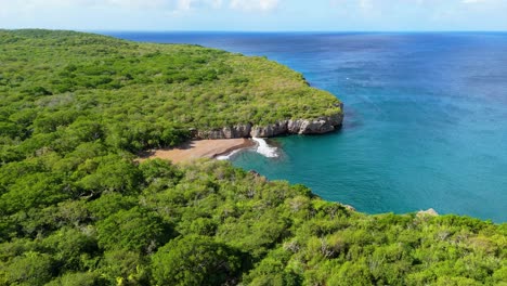 Aerial-establish-of-playa-Santu-Pretu-black-sand-beach-cove-and-shallow-reef-ledge