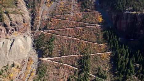 Pullback-drone-shot-revealing-Black-Bear-Pass-off-road-trail-in-Telluride,-CO