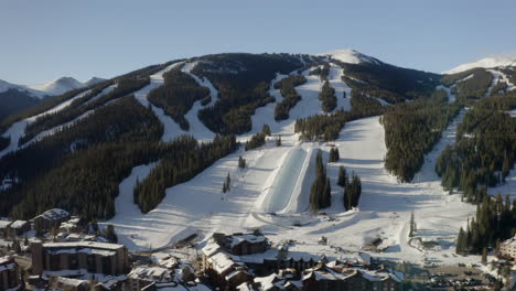 Aerial-Drone-Copper-Mountain-Colorado-Ikon-Epic-Pass-winter-spring-sunny-first-light-sunrise-morning-sunset-half-pipe-chairlift-ski-runs-center-village-cinematic-slowly-down-jib-motion
