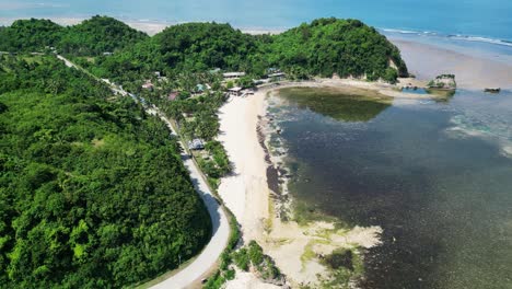 Twin-rock-resort-in-virac,-catanduanes-with-lush-foliage-and-clear-waters,-aerial-view