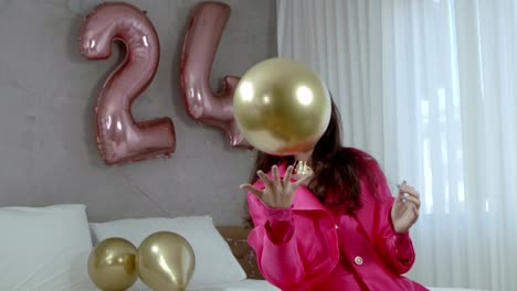 Young-woman-struggles-to-contain-birthday-balloon-delight