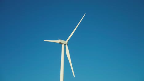 Isolated-wind-turbine-with-clear-blue-sky-on-the-background