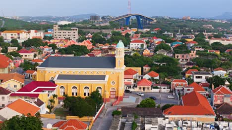 Aerial-wide-angle-establishes-Santa-Famia-church-and-Queen-Juliana-bridge-Otrobanda-Curacao