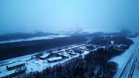 Aerial-4K-Sunrise-Blue-Hour-Morning-Cinematic-4K-Blizzard-Snowfall-Foggy-Drone-Shot-of-Arctic-Winter-Community-Isolated-Remote-Mining-Village-Hub-of-the-North-Thompson-Manitoba-Canada-Vale-Inco-Mine