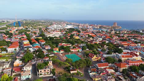 Aerial-descend-establishes-tropical-Otrobanda-Willemstad-port-with-ship,-Caribbean-Destination-of-Curacao