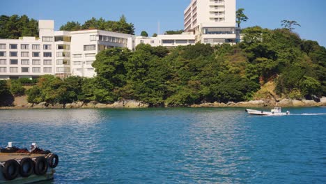Toba-Port-in-Mie-Prefecture-Japan,-Seaside-Town-as-Boat-Passes-By