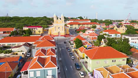 Aerial-dolly-establish-Santa-Famia-church-Otrobanda-Curacao-vibrant-colorful-homes