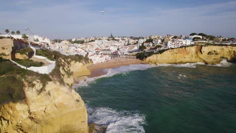 Aerial-Flying-Past-Alto-da-Praia-do-Carvoeiro-With-Beach-In-Background-And-Waves-Breaking