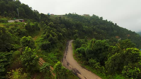 Aerial-shot-over-a-road-through-Nepali-landscape