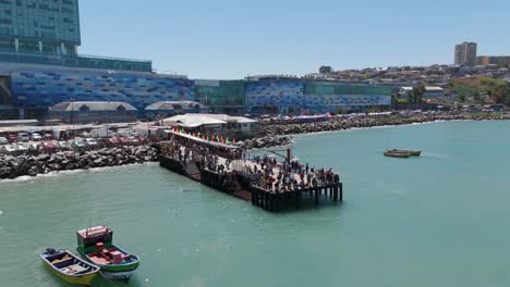 Pier-With-Crowds-Of-People-Near-San-Antonito-Port-In-Chile-With-Muelle-Behind