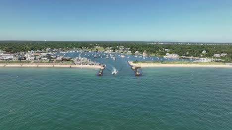Drone-shot-of-a-motorboat-leaving-the-safety-of-the-Martha's-Vineyard-marina