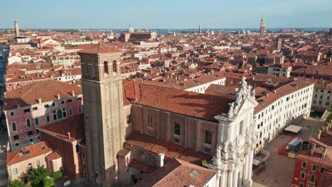 Santa-Maria-Assunta-church-in-Venice-with-cityscape,-clear-day,-aerial-view