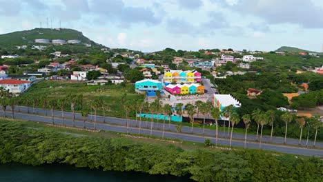 Aerial-orbit-of-vibrant-rainbow-colored-homes-on-hillside-of-Otrobanda-Curacao