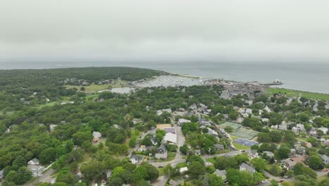 Wide-drone-shot-approaching-a-seaside-town-in-Cape-Cod,-Massachusetts