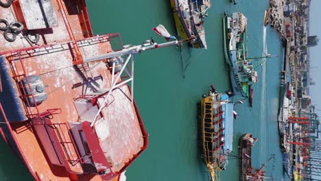 Aerial-View-Over-Moored-Fishing-Boats-In-Port-Of-San-Antonio-In-Chile