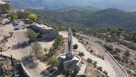 AERIAL-ORBITAL-around-Statue-of-Our-Lady-of-Cabeza-in-scenic-Andalusia-landscape-Spain