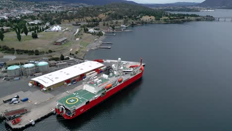 RSV-Nuyina-Australia-Icebreaker-at-port-bridge-drone-aerial-tilt-up-50fps