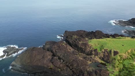 Rocky-coastline-with-lush-greenery-and-tranquil-sea,-catanduanes,-aerial-view