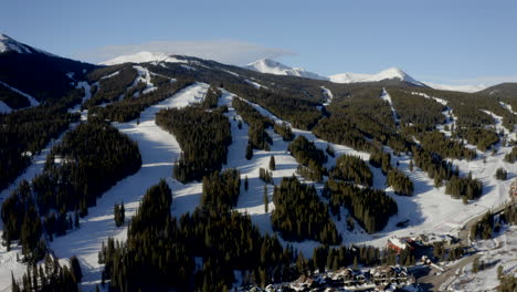 Aerial-Drone-Copper-Mountain-Colorado-Ikon-Epic-Pass-winter-spring-sunny-first-light-sunrise-morning-sunset-half-pipe-chairlift-ski-runs-east-village-Vail-Pass-cinematic-slowly-circle-right-motion