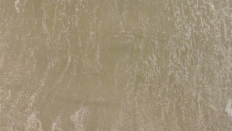 Foamy-Ocean-Waves-Washing-Sand-Of-Tropical-Beach---Top-Down-View