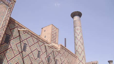 detailed-tiling-on-minaret-and-wall-of-mosque-in-Samarkand,-Uzbekistan-along-the-historic-Silk-Road