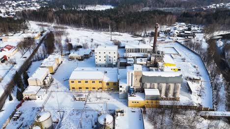 Drone-view-industrial-building-of-electric-utility-company-in-city-of-Silute-in-winters,-Lithuania