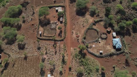 Homesteads-in-traditional-Masai-village-at-Mount-Kilimanjaro-footstep,-Kenya,-aerial-top-down