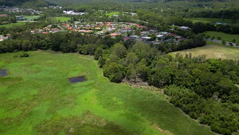 Aerial-over-Mudgeeraba-Creek,-Firth-Park-and-residential-housing-in-Mudgeeraba,-Gold-Coast,-Queensland,-Australia