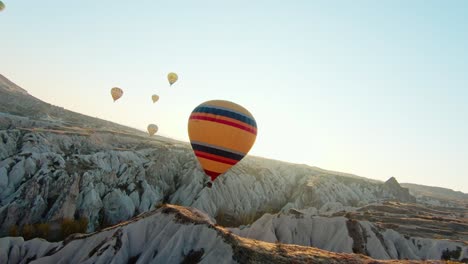 Hot-Air-Balloons-Over-Cappadocia-Landscape-At-Sunrise-In-Turkey