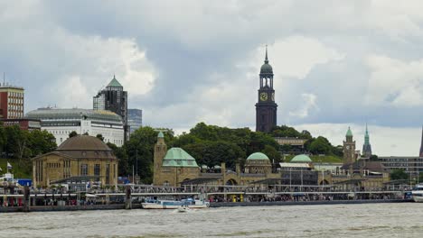 Cinematic-shot-of-Hamburg-city-with-skyscape-at-background-and-speedboats-on-sea-in-Germany