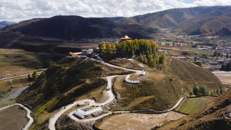 Aerial-pullback-establishes-Sichuan-Bamei-temple-on-prominent-hill-with-winding-road