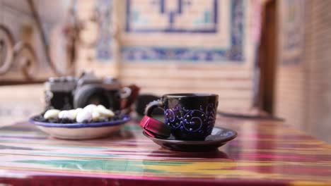 sipping-a-cafe-espresso-at-a-small-cafe-in-the-registan-in-Samarkand,-Uzbekistan-along-the-historic-Silk-Road