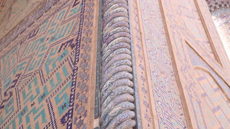 ornate-spiraling-blue-column-on-the-front-of-madrassa-in-Samarkand,-Uzbekistan-along-the-historic-Silk-Road
