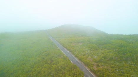 Countryside-Road-Between-Green-Forests-On-A-Misty-Day-In-Madeira,-Portugal---Aerial-Shot