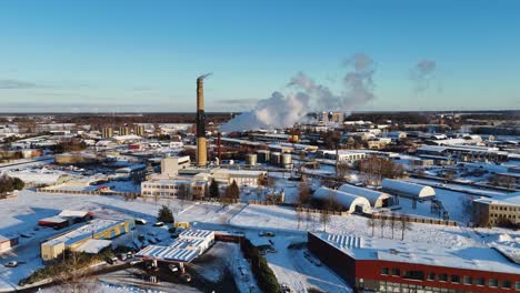 Cinematic-drone-shot-of-industrial-landscape,-Steam-coming-out-of-chimney,-Silute,-Lithuania