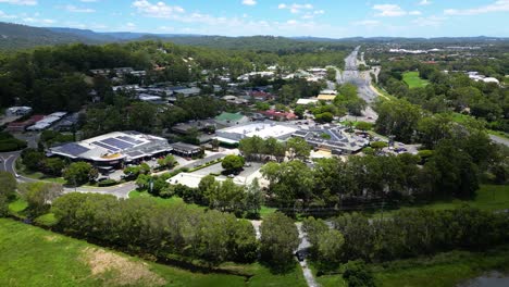 Aerial-over-Mudgeeraba-Market-Shopping-Centre-and-Firth-park,-Gold-Coast,-Queensland,-Australia