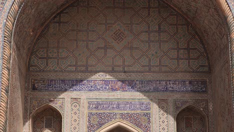 lights-and-shadows-hit-the-arched-doorway-of-islamic-architecture-in-Samarkand,-Uzbekistan-along-the-historic-Silk-Road