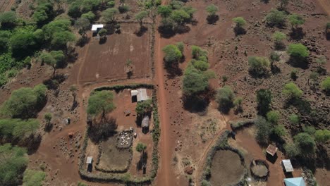 Masai-farms-on-arid-savanna-in-Southern-Kenya,-aerial-top-down