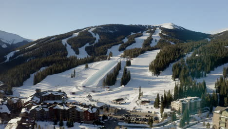 Aerial-Drone-Copper-Mountain-Colorado-Ikon-Epic-Pass-winter-spring-sunny-first-light-sunrise-morning-sunset-half-pipe-chairlift-ski-runs-center-village-slowly-upward-jib-motion