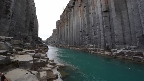 Studlagil-Magnificent-rock-formations-surrounding-a-beautiful-blue-river