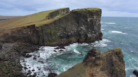 The-stunning,-rugged-coastline-of-Valahnúkamöl-in-Iceland-with-a-dramatic-cliff-towering-over-a-bay