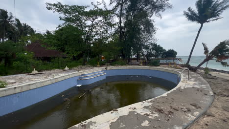 Verlassener,-Heruntergekommener-Pool-Mit-Schmutzigem-Wasser-Neben-Dem-Strand,-Gili-Air-Island,-Indonesien