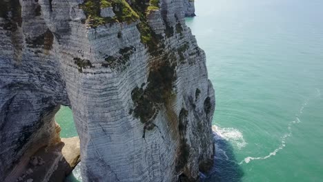 Flying-backward-looking-at-the-rocks-of-Etretat-in-France