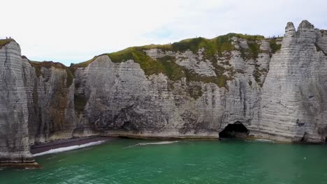 Flying-close-to-the-rocky-wall-next-to-the-arch-of-Etretat-on-the-coast-of-Normandy